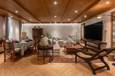 a living room with a table and a couch and a television at Presidential Suite | 5 min BTS, Sun-Room| 159sqm in Khlong Toei
