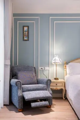 a bedroom with a chair and a bed at Chic 1BR |5 min BTS, 2 min to spa|500Mbps&bath-tub in Khlong Toei