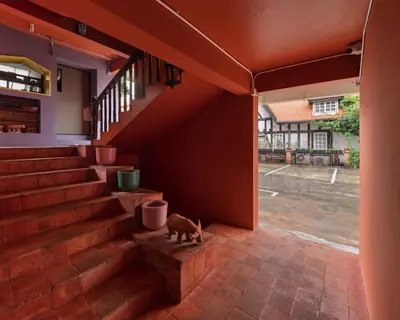 a cat sitting on the steps of a house at Chic 1BR |5 min BTS, 2 min to spa|500Mbps&bath-tub in Khlong Toei