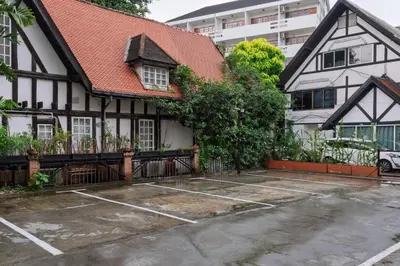 a house with a parking lot in front of it at Chic 1BR |5 min BTS, 2 min to spa|500Mbps&bath-tub in Khlong Toei