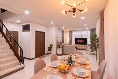 a dining room with a table and chairs at ThongLor|Spacious 4BR4BA, Fast-WiFi, Netflix, Shop in Khlong Toei
