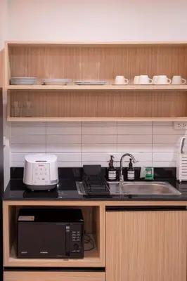 a kitchen with a sink and a microwave at ThongLor|Spacious 4BR4BA, Fast-WiFi, Netflix, Shop in Khlong Toei