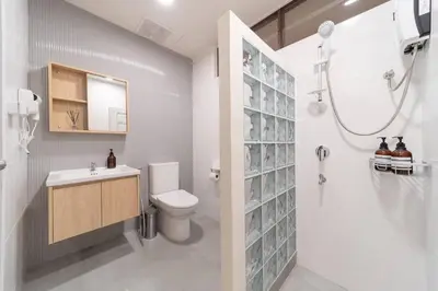 a bathroom with a shower and a toilet and a sink at ThongLor|Spacious 4BR4BA, Fast-WiFi, Netflix, Shop in Khlong Toei