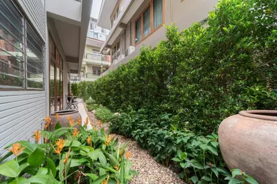 a garden in front of a building with plants at Spacious CityCentre | 500 mbps, King-size, Balcony in Khlong Toei