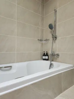 a white bath tub in a bathroom at White House Ekkamai in Bangkok