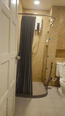 a shower with a shower curtain in a bathroom at indra apartments in Bangkok