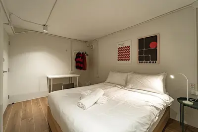 a bedroom with a white bed with towels on it at Cozy 3BR for 8 People, 5Mins from MRT Huai Khwang in Bangkok