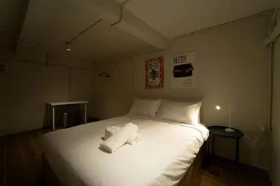 a bedroom with a white bed with two towels on it at Cozy 3BR for 8 People, 5Mins from MRT Huai Khwang in Bangkok