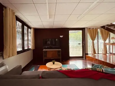 a living room with a couch and a table at 4BR House max 10pax, Near MRT and Local Place