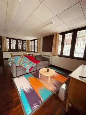 a living room with a couch and a table at 4BR House max 10pax, Near MRT and Local Place