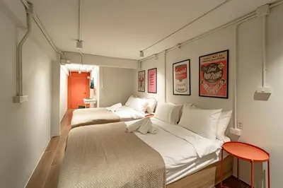 a bedroom with two beds and a red stool at 2BR APT on 2nd floor for 6 ppl in Bangkok