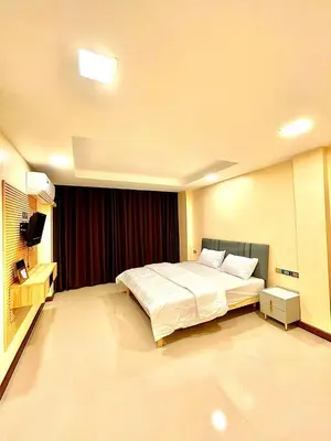 a bedroom with a large bed in a room at The Little Apartment in Bangkok