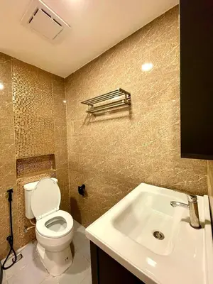 a bathroom with a toilet and a sink at The Little Apartment in Bangkok