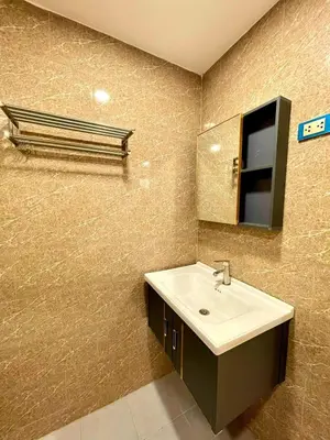 a bathroom with a sink and a mirror at The Little Apartment in Bangkok