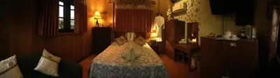 a bedroom with a bed with a comforter on it at Shanti Lodge Bangkok in Bangkok