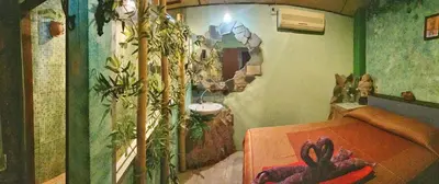 a bathroom with a bath tub and a sink at Shanti Lodge Bangkok in Bangkok