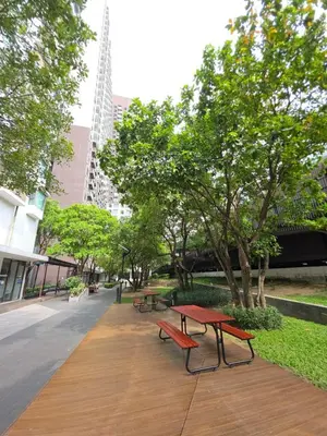 a picnic table and benches in a park at FavStay Ramkhamhaeng, Stylish 1BR Bangkok in Bangkok