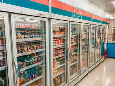 a grocery store aisle with refrigerators and drinks at Lucky Green View in Bangkok