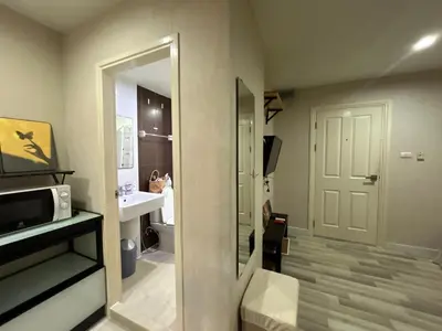 a bathroom with a door leading to a bathroom with a sink at Secret Pastel Room Laksi Donmuang Airport ห้องลับพาสเทลหลักสี่สนามบินดอนเมือง in Lak Si