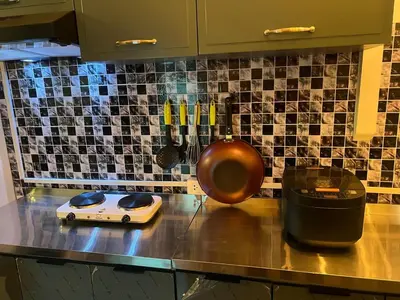 a kitchen counter with a counter top with aperature at LA CASA in China town in Bangkok