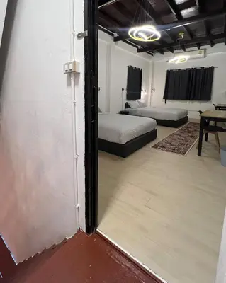 a room with two beds and a sliding glass door at LA CASA in China town in Bangkok