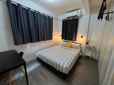 a bedroom with a bed with a teddy bear on it at LA CASA in China town in Bangkok
