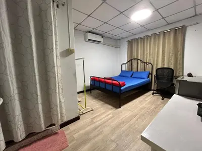 a hospital room with a bed and a table at Wewash Room Laksi - Donmuang Airport ห้องวีวอช หลักสี่ -สนามบินดอนเมือง in Thung Si Kan