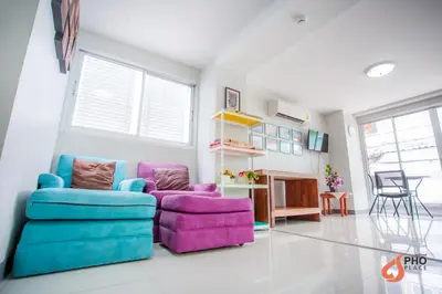 a living room with two chairs and a couch at Pho Place in Bangkok