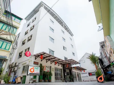 a white building with a sign in front of it at Pho Place in Bangkok