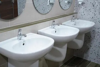 two white sinks in a bathroom with mirrors at Cozy KingsizeBed เจริญนคร
