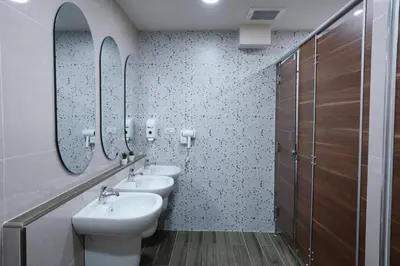 a bathroom with two sinks and two mirrors at Cozy KingsizeBed เจริญนคร