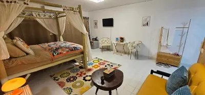 a bedroom with a bed and a table and chairs at Hotel pretty rooms in Pak Kret