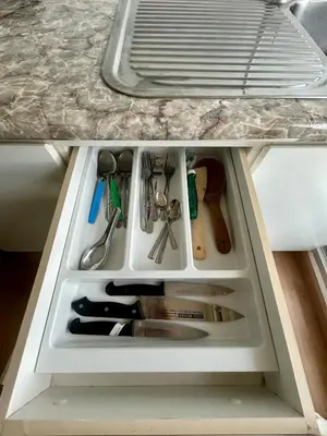 a drawer in a refrigerator filled with cooking utensils at Sky View at The Parkland Ngamwongwan-Khae Rai by Orn in Nonthaburi