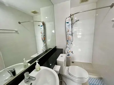 a bathroom with a toilet and a sink and a shower at Sky View at The Parkland Ngamwongwan-Khae Rai by Orn in Nonthaburi