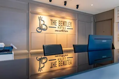 a meeting room with a sign on the wall at The Bentley Hotel in Bangkok