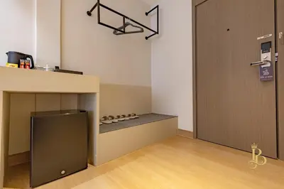 a room with a counter and a door with a shelf at The Bentley Hotel in Bangkok