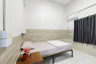 a hospital room with a bed and a table at Room 1 Homestay Near BTS Bangwa in Bangkok