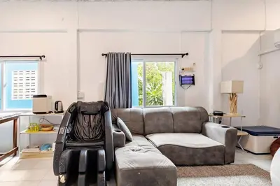 a living room with a couch and a chair at Room 1 Homestay Near BTS Bangwa in Bangkok