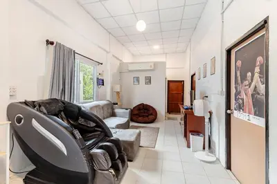 a living room with a couch and a chair at Room 1 Homestay Near BTS Bangwa in Bangkok