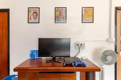 a desk with a monitor and a laptop on it at Room 1 Homestay Near BTS Bangwa in Bangkok