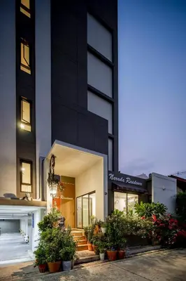 a store front of a building with potted plants at Narada Residence in Pak Kret