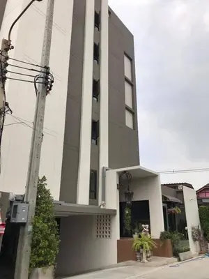 a large white building with plants in front of it at Narada Residence in Pak Kret