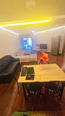 a living room with a table and a couch at River View Bangkok Apartment in Bangkok