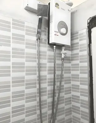 a shower in a bathroom with a wall mounted shower at XX Oh My Nap Nana Soi 3 -โอมาย แนปเทล ซอย 3 in Makkasan