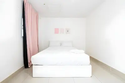 a small white room with two beds in it at XX Oh My Nap Nana Soi 3 -โอมาย แนปเทล ซอย 3 in Makkasan