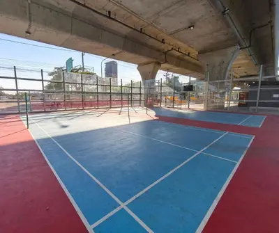 an empty tennis court in a building at Amina Residence in Ban Sai Ma