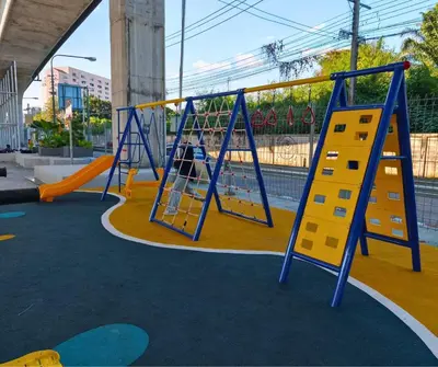 a playground with two swings and a slide at Amina Residence in Ban Sai Ma