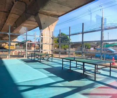 a group of ping pong tables in a building at Amina Residence in Ban Sai Ma