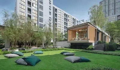 a garden with three large pillows on the grass at 1 bed apartment at Phra Khnong in Bangkok