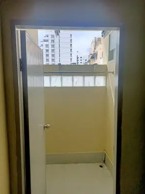 an open door to a bathroom with a window at KT MANSION Victory Monument in Bangkok